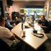 WTKA 1050 radio host Ira Weintraub (right) chats with former Michigan football player Mike Hart and former assistant coach Jerry Hanlon during a fundraiser for Mott Children's Hospital at the station on Friday. Melanie Maxwell I AnnArbor.com